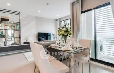 Luxurious modern living room with dining area and balcony view in high-rise apartment.
