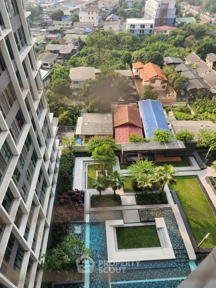 Stunning aerial view of modern residential building with lush garden and pool