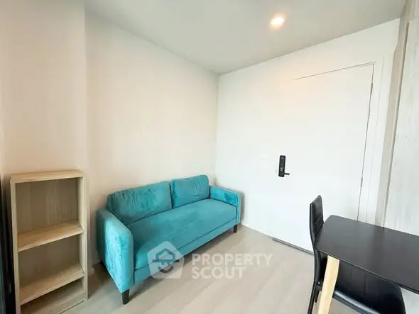 Modern living room with teal sofa and minimalist decor