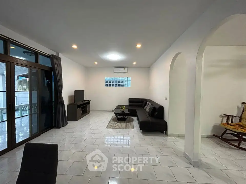 Spacious living room with modern furniture and large windows for natural light.