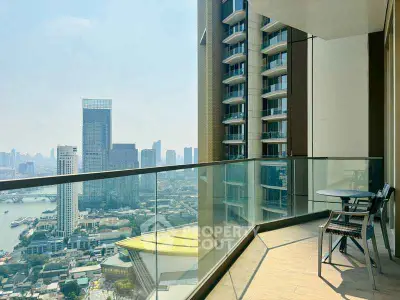 Luxurious high-rise balcony with stunning cityscape view and modern glass railing.