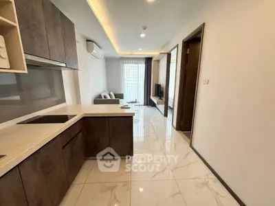 Modern open-layout kitchen and living room with sleek design and natural light