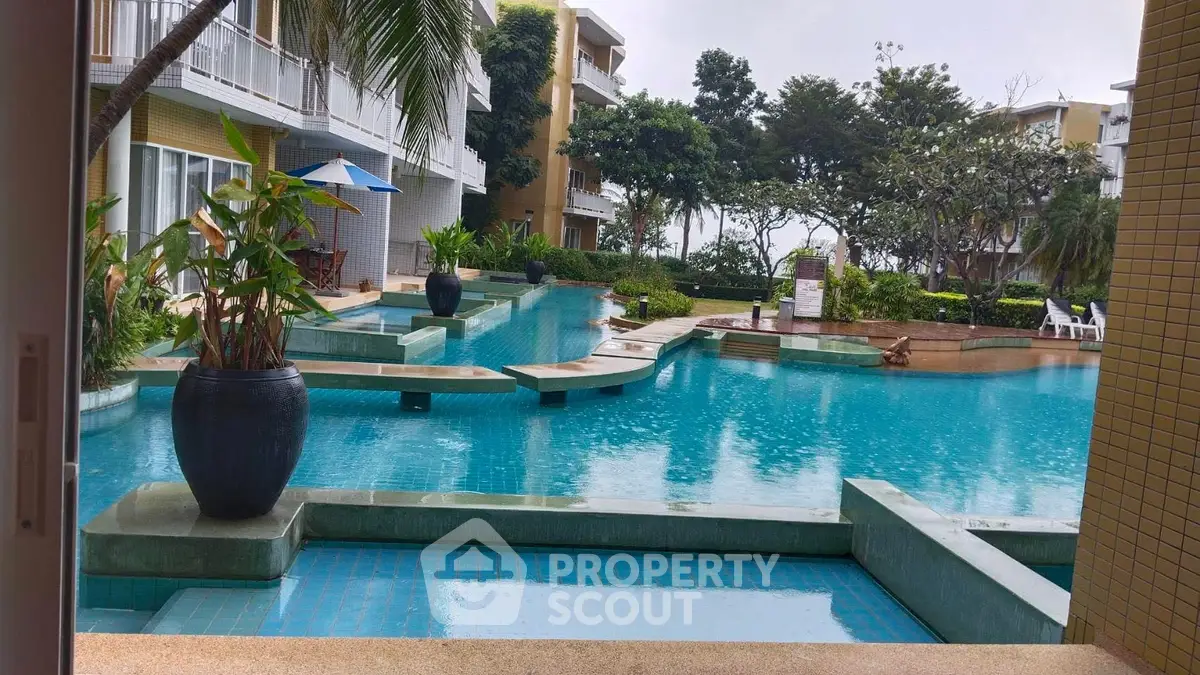 Luxurious poolside view with modern architecture and lush greenery