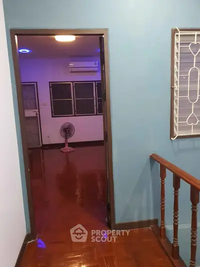 Charming interior view with polished wooden floors and modern lighting, ideal for cozy living.