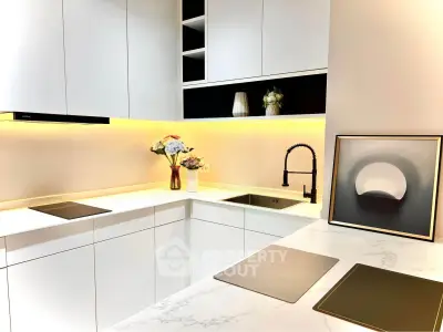 Modern kitchen with sleek white cabinetry and elegant decor