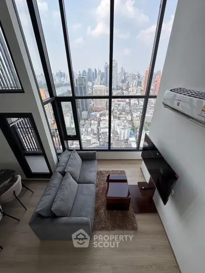 Stunning high-rise living room with panoramic city view and modern furnishings.