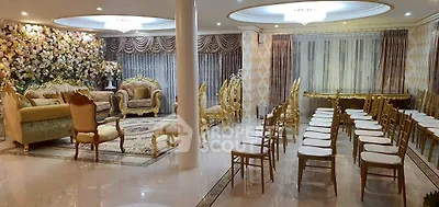 Luxurious living room with elegant gold furniture and floral wall decor