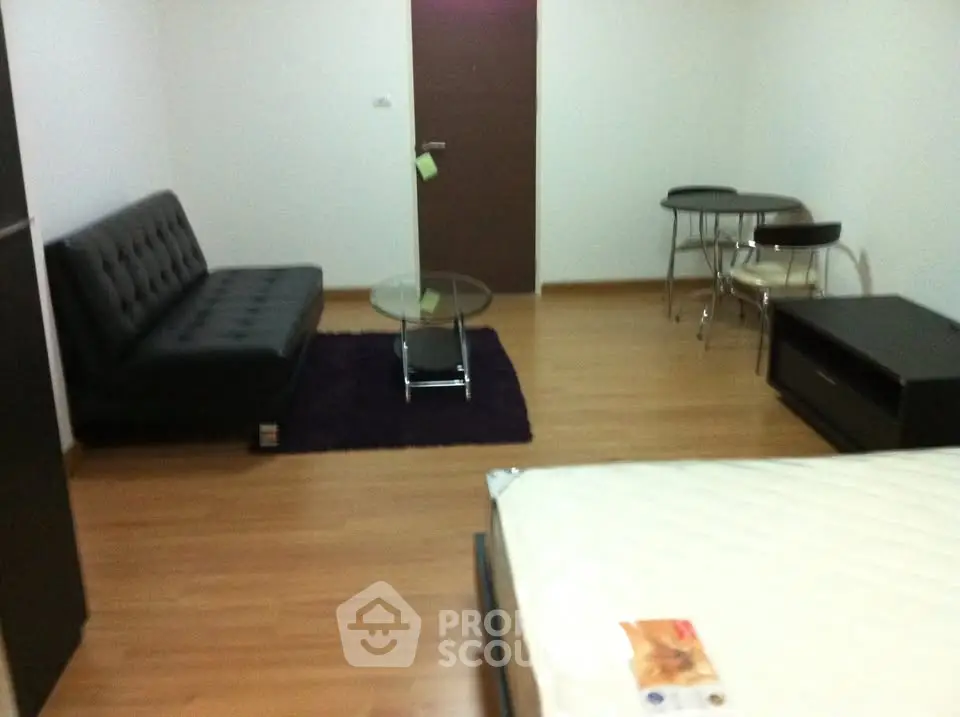 Modern studio apartment with sleek furniture and wooden flooring