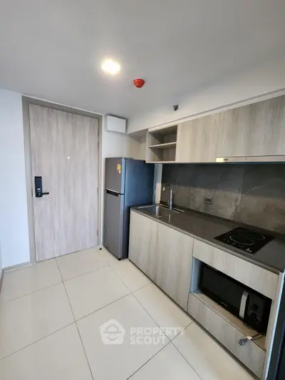 Modern kitchen with sleek cabinets and appliances in a contemporary apartment