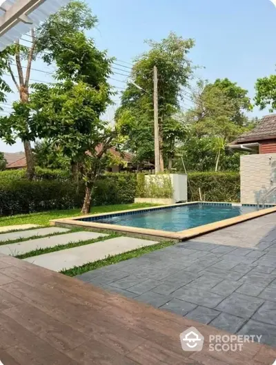 Stunning backyard with private pool and lush greenery, perfect for relaxation and outdoor entertainment.