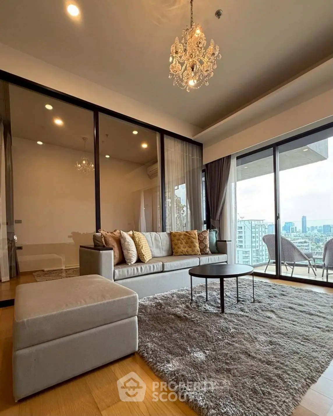 Luxurious living room with chandelier and city view from large windows