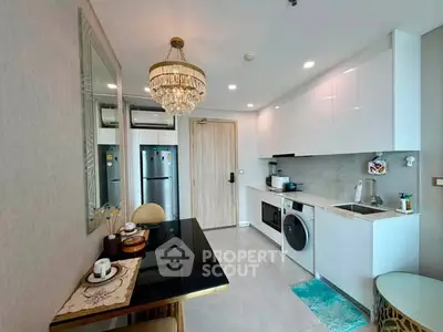 Modern kitchen with sleek white cabinets, integrated appliances, and elegant dining area.