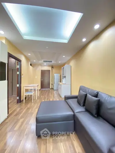 Modern living room with sleek furniture and ambient lighting in a stylish apartment.