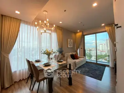 Elegant living room with city view, modern decor, and dining area in high-rise apartment.