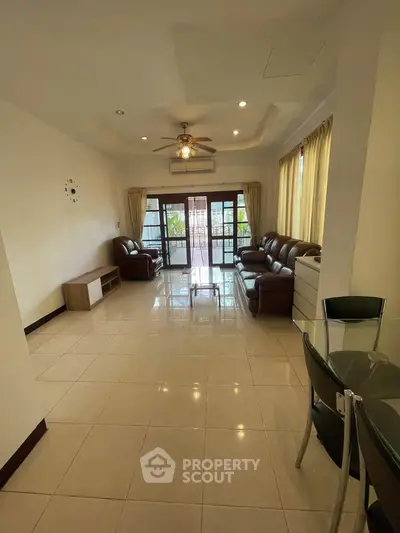 Spacious living room with elegant furniture and large windows for natural light.