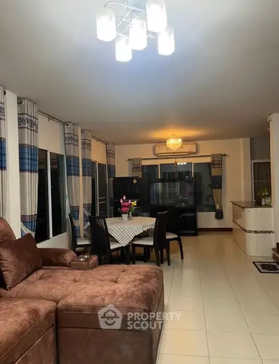 Spacious living room with modern decor and open layout dining area