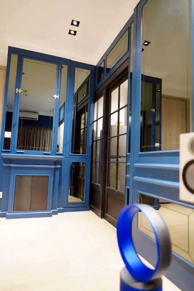 Stylish modern interior with blue cabinetry and mirrored accents
