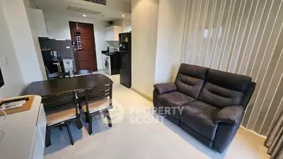 Modern living room with cozy sofa and dining area in open layout apartment.