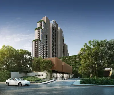 Modern high-rise building with lush greenery and sleek design in urban setting.