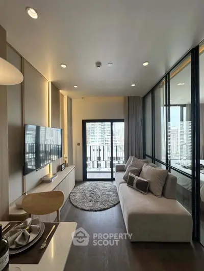 Modern living room with large windows and city view, featuring stylish furniture and elegant decor.