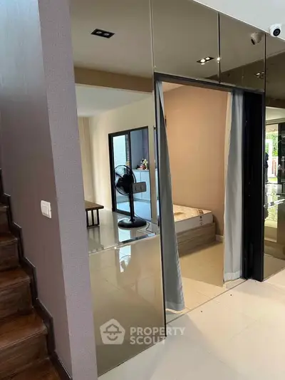 Modern interior with mirrored walls and cozy bedroom view