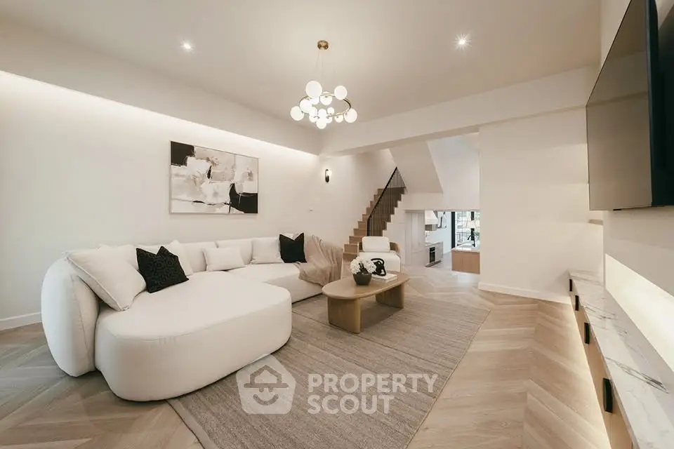 Luxurious modern living room with elegant decor and spacious layout, featuring stylish furniture and ambient lighting.