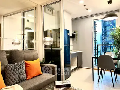 Modern open-plan living room with stylish decor and dining area, featuring large windows and sleek furniture.