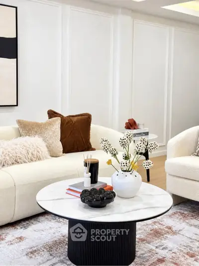 Elegant living room with modern decor and cozy seating area, featuring stylish furniture and chic accents.