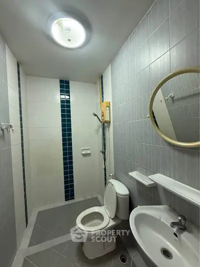 Compact bathroom with modern fixtures and stylish tile accents