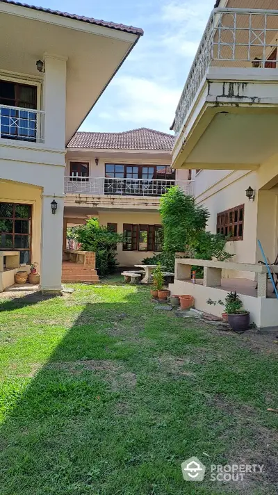 Charming two-story home with lush garden and spacious balconies