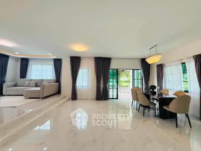 Spacious modern living room with elegant dining area and large windows for natural light.