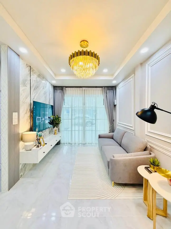 Luxurious living room with elegant chandelier and modern decor