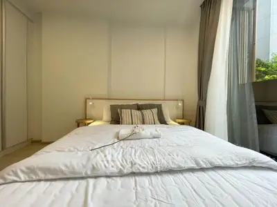 Bright and cozy bedroom with large window and modern decor