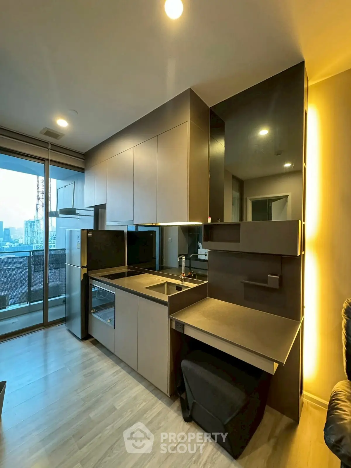 Modern kitchen with sleek cabinetry and city view from balcony
