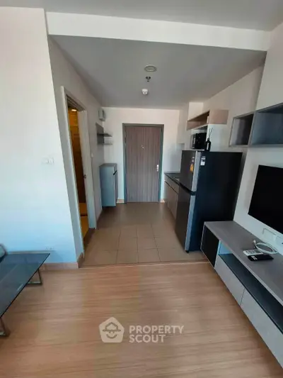 Modern apartment entrance with sleek kitchen and stylish living area