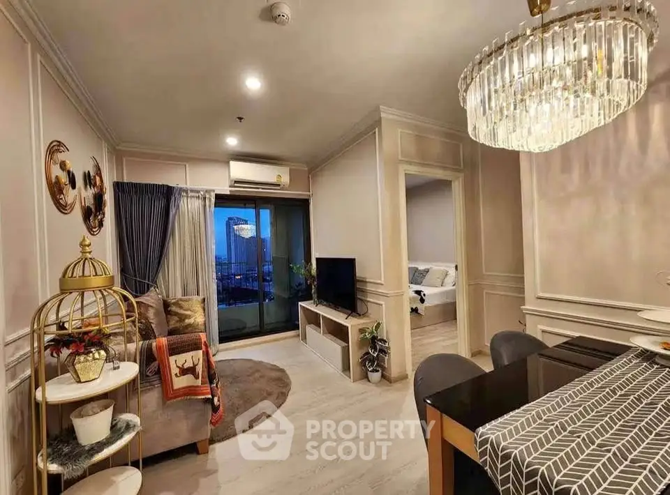 Elegant living room with modern decor and dining area, featuring a large chandelier and balcony view.