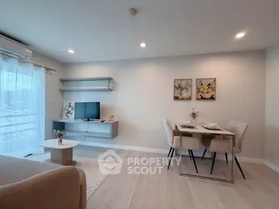 Modern living room with dining area, stylish decor, and natural light