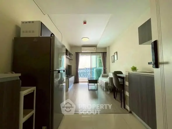 Modern living room with balcony and sleek kitchen appliances