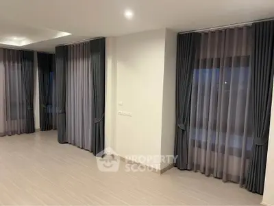 Spacious modern living room with elegant curtains and sleek flooring