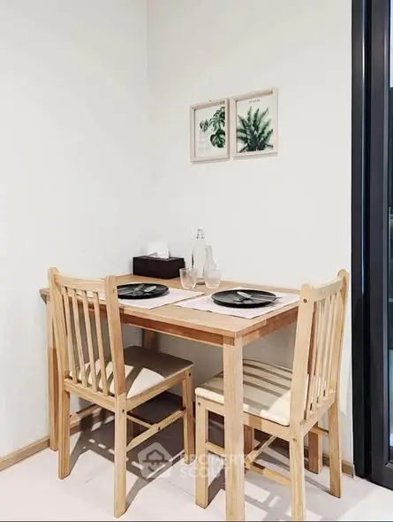 Cozy dining nook with wooden table and chairs, perfect for intimate meals.