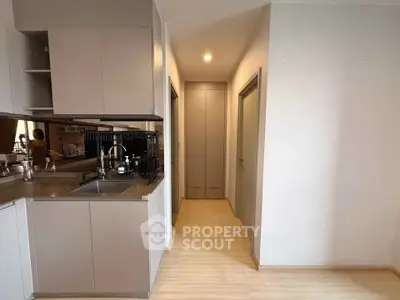 Modern kitchen with sleek cabinetry and open layout in a stylish apartment