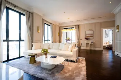 Luxurious living room with elegant decor, large windows, and plush seating in a modern apartment.
