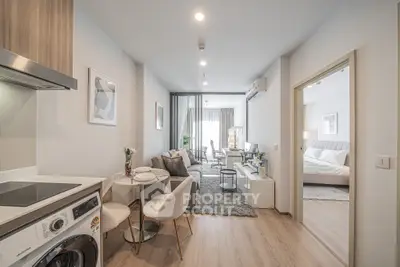 Modern open-plan living room with kitchen and bedroom in stylish apartment