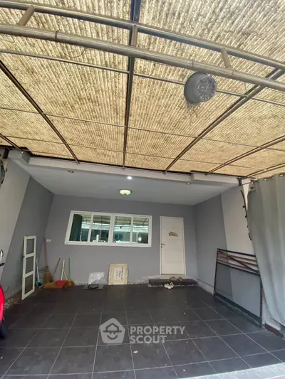 Spacious garage with tiled flooring and ample storage potential