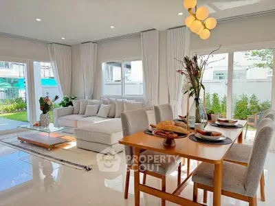 Spacious modern living room with elegant dining area and garden view