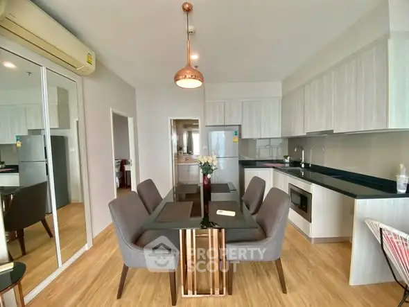 Modern dining area with sleek kitchen in open layout apartment