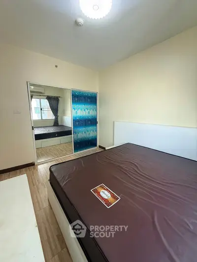 Spacious bedroom with modern decor and large mirror closet doors