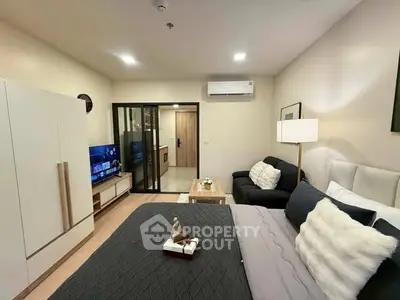 Modern studio apartment with cozy living area and stylish decor
