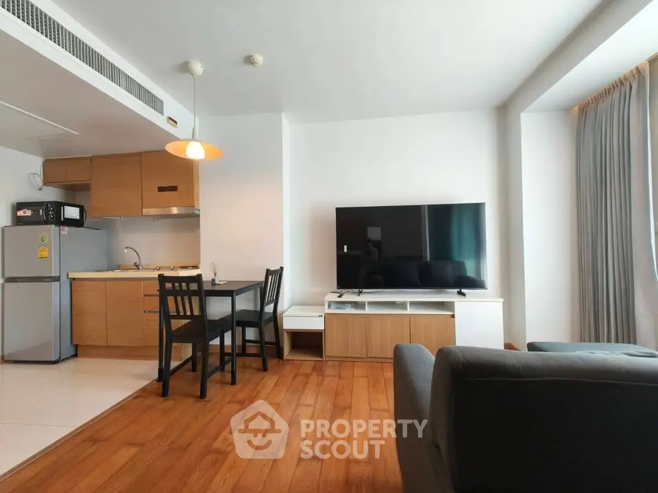 Modern living room with open kitchen and stylish furniture in a cozy apartment