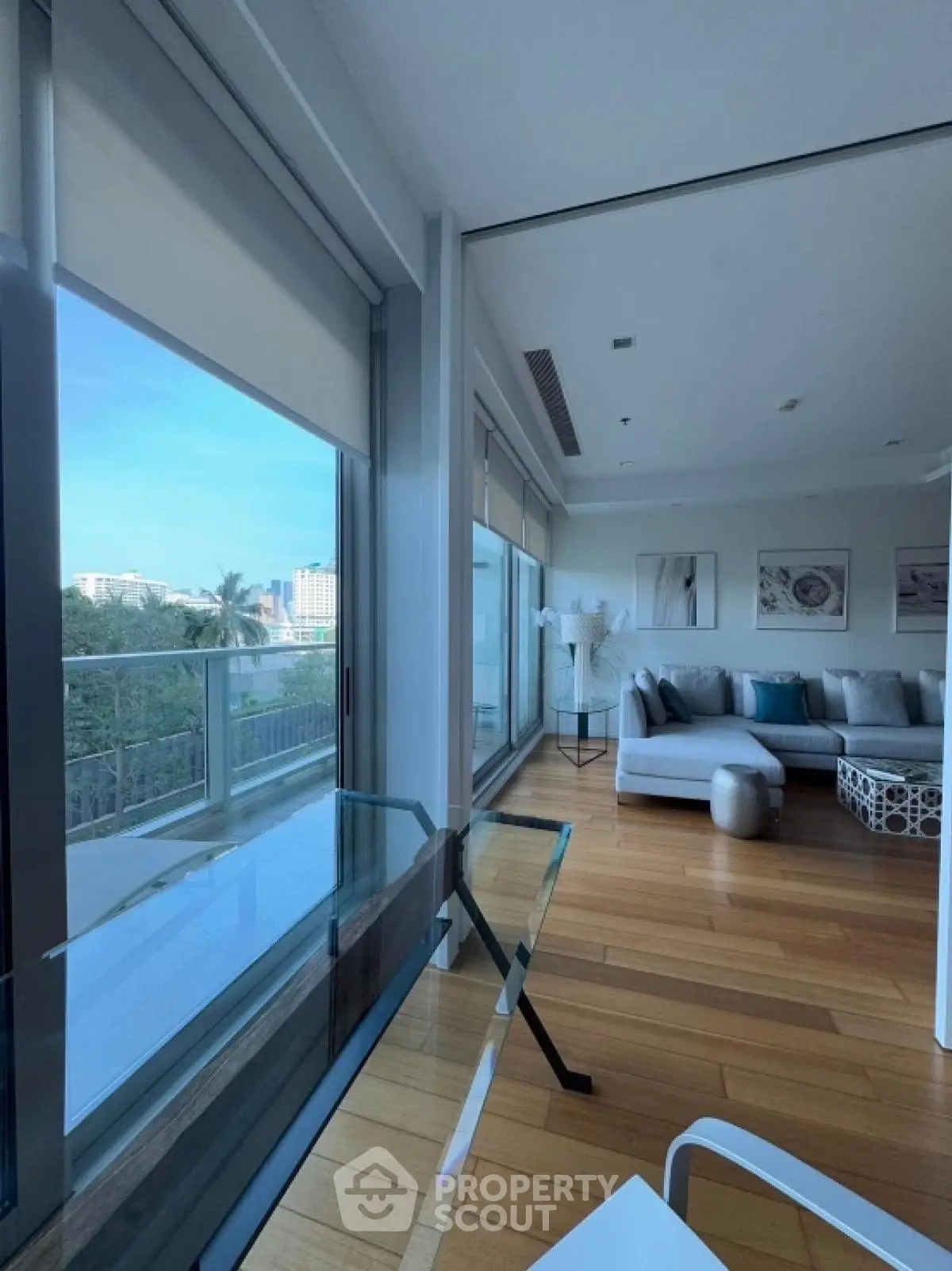 Spacious modern living room with large windows and balcony view
